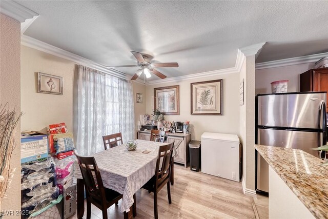 4050 Pacific Harbors Dr Unit 107, Las Vegas, NV 89121 - dining area featuring crown molding, ceiling fan, light wood-type flooring, and a textured ceiling