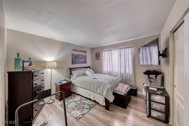 4050 Pacific Harbors Dr Unit 107, Las Vegas, NV 89121 - bedroom with light wood finished floors and baseboards