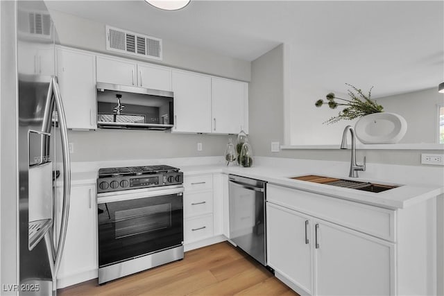 5710 E Tropicana Ave Unit 2152, Las Vegas, NV 89122 - kitchen with stainless steel appliances, a sink, light countertops, and white cabinetry