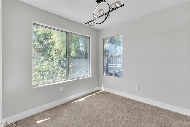 5710 E Tropicana Ave Unit 2152, Las Vegas, NV 89122 - carpeted spare room featuring plenty of natural light, a chandelier, and baseboards