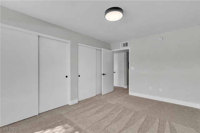 5710 E Tropicana Ave Unit 2152, Las Vegas, NV 89122 - unfurnished bedroom featuring multiple closets, carpet flooring, and baseboards