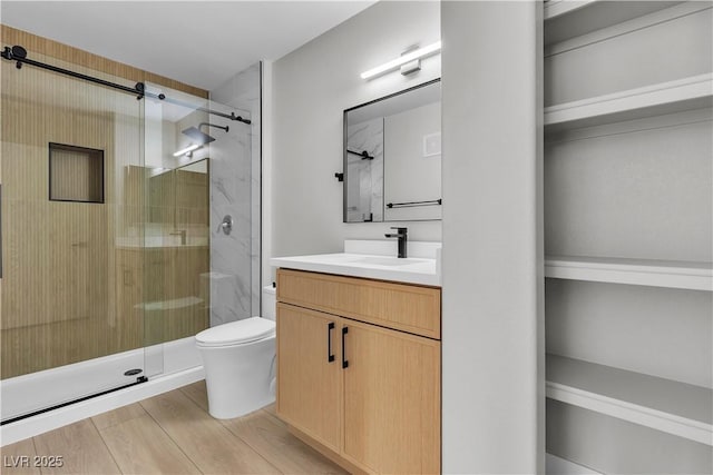 5710 E Tropicana Ave Unit 2152, Las Vegas, NV 89122 - full bath with a shower stall, toilet, vanity, and wood finished floors