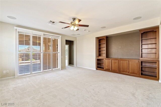 11177 Twilight Times Ct, Las Vegas, NV 89135 - unfurnished living room featuring a ceiling fan, light colored carpet, and baseboards