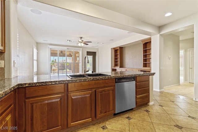11177 Twilight Times Ct, Las Vegas, NV 89135 - kitchen with dishwasher, a sink, baseboards, light tile patterned floors, and brown cabinets