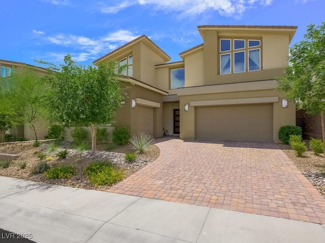 3 Hilltop Crest St, Henderson, NV 89011 - view of front of house with an attached garage, stucco siding, and decorative driveway
