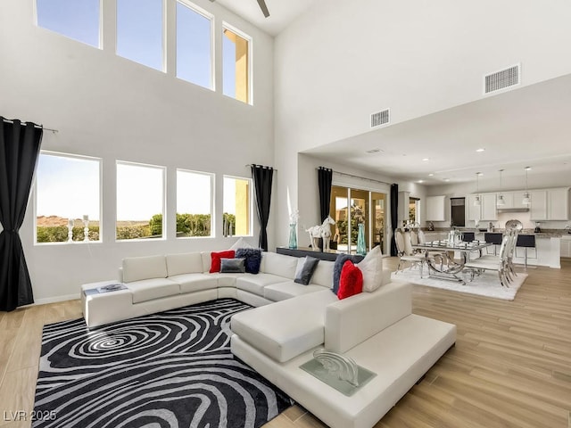 3 Hilltop Crest St, Henderson, NV 89011 - living area with a high ceiling and light wood-style flooring