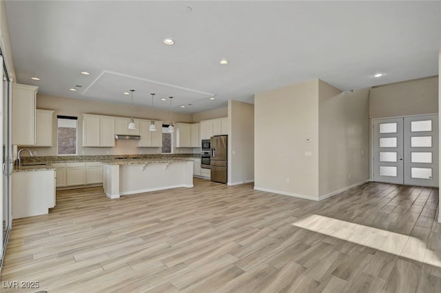 3 Hilltop Crest St, Henderson, NV 89011 - kitchen with appliances with stainless steel finishes, a sink, open floor plan, a kitchen bar, and a center island