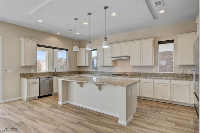 3 Hilltop Crest St, Henderson, NV 89011 - kitchen featuring appliances with stainless steel finishes, a center island, white cabinets, under cabinet range hood, and recessed lighting