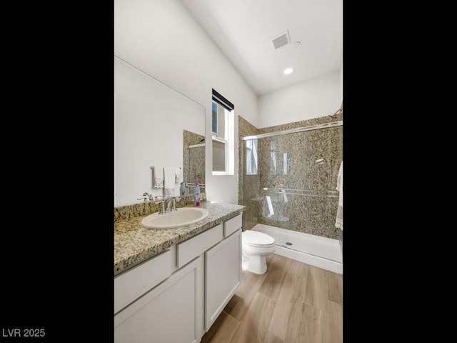 3 Hilltop Crest St, Henderson, NV 89011 - bathroom featuring a shower stall, toilet, vanity, and wood finished floors