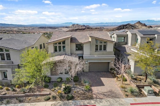 3 Hilltop Crest St, Henderson, NV 89011 - view of front of house featuring stucco siding, a mountain view, driveway, an attached garage, and a residential view