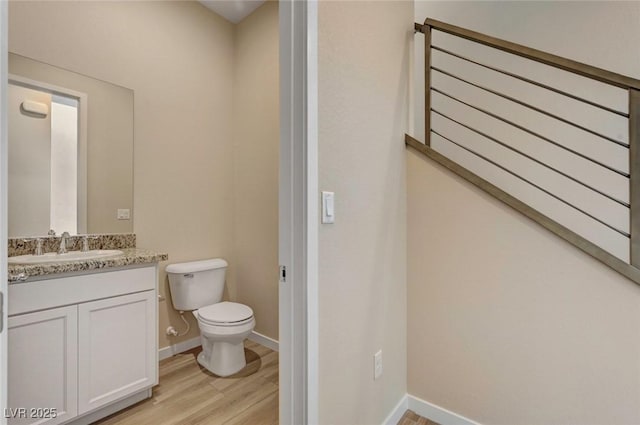 3 Hilltop Crest St, Henderson, NV 89011 - half bathroom with toilet, wood finished floors, vanity, and baseboards