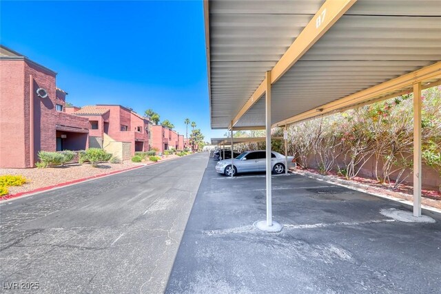 4050 Pacific Harbors Dr Unit 245, Las Vegas, NV 89121 - covered parking lot featuring a residential view