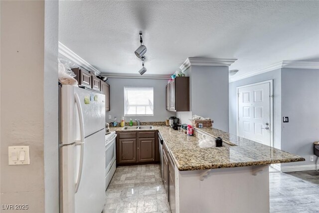4050 Pacific Harbors Dr Unit 245, Las Vegas, NV 89121 - kitchen with white appliances, a peninsula, crown molding, a sink, and light stone counters