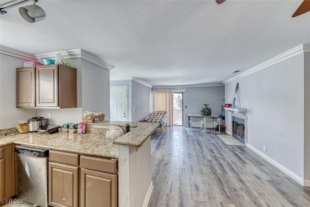 4050 Pacific Harbors Dr Unit 245, Las Vegas, NV 89121 - kitchen with dishwasher, light wood finished floors, a textured ceiling, crown molding, and light stone countertops