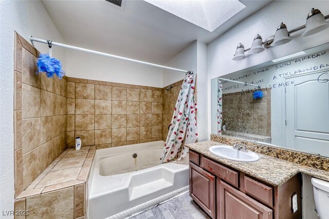 4050 Pacific Harbors Dr Unit 245, Las Vegas, NV 89121 - bathroom with a skylight, shower / bath combo with shower curtain, vanity, and toilet