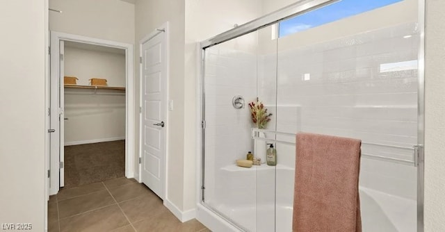 4200 E Brusca Way, Pahrump, NV 89061 - bathroom featuring a stall shower, tile patterned floors, a spacious closet, and baseboards