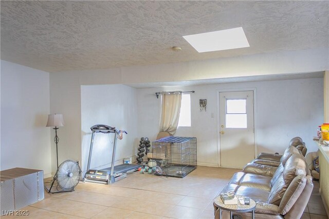 2001 E Mcwilliams Ave, Las Vegas, NV 89101 - tiled living area featuring a skylight and a textured ceiling