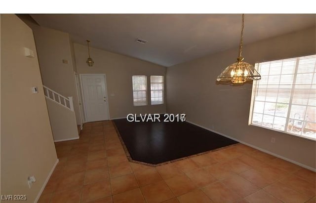 7518 Luna Del Rey St, Las Vegas, NV 89123 - tiled empty room with plenty of natural light, a chandelier, lofted ceiling, baseboards, and stairway