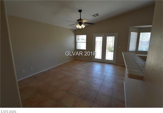 7518 Luna Del Rey St, Las Vegas, NV 89123 - unfurnished dining area with tile patterned flooring, ceiling fan, french doors, lofted ceiling, and baseboards