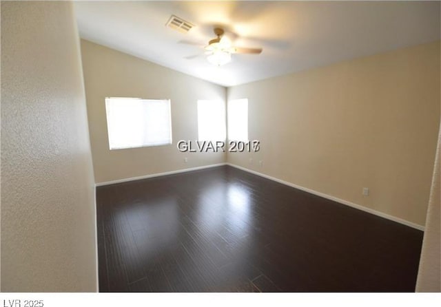 7518 Luna Del Rey St, Las Vegas, NV 89123 - empty room featuring ceiling fan, dark wood-style floors, baseboards, and vaulted ceiling
