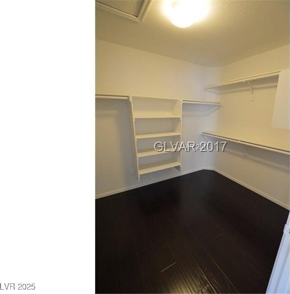 7518 Luna Del Rey St, Las Vegas, NV 89123 - walk in closet with dark wood-style flooring