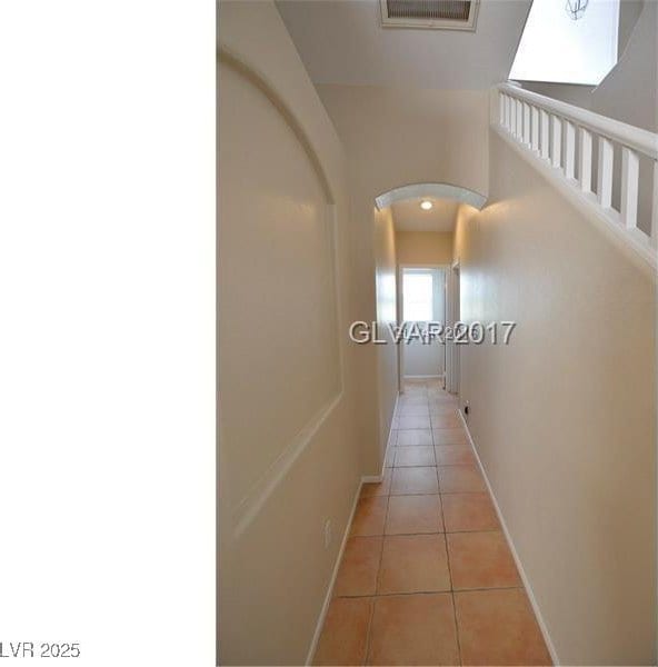 7518 Luna Del Rey St, Las Vegas, NV 89123 - hall with light tile patterned floors, arched walkways, and baseboards
