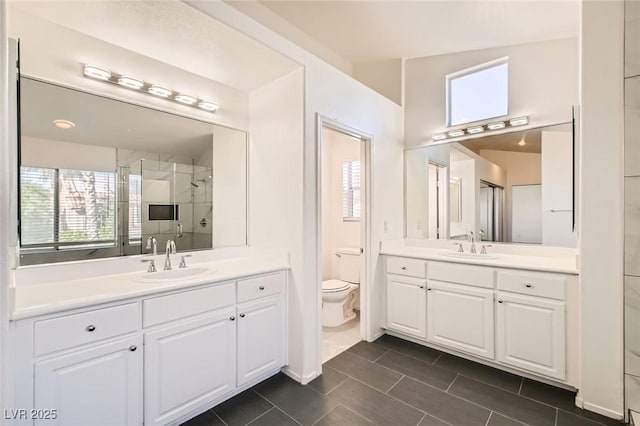 10241 Regents Cross Pl, Las Vegas, NV 89144 - full bathroom with a stall shower, two vanities, toilet, and tile patterned flooring