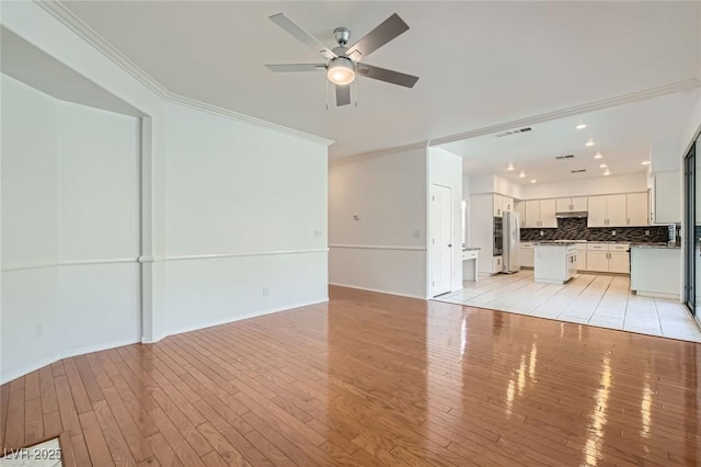 10241 Regents Cross Pl, Las Vegas, NV 89144 - unfurnished living room with ceiling fan, light wood finished floors, crown molding, and baseboards