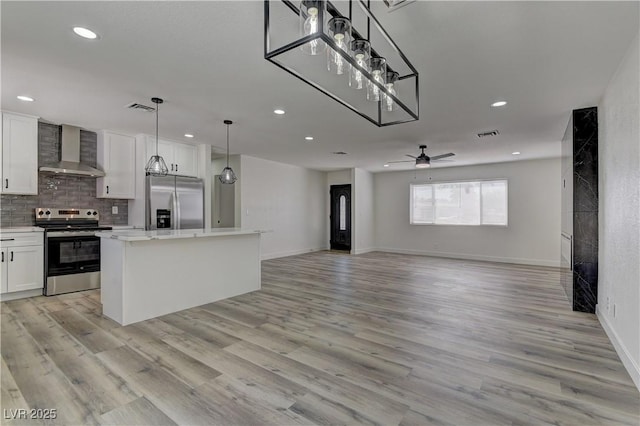 1901 Farnam Pl, Las Vegas, NV 89102 - kitchen with appliances with stainless steel finishes, wall chimney exhaust hood, recessed lighting, a center island, and white cabinetry
