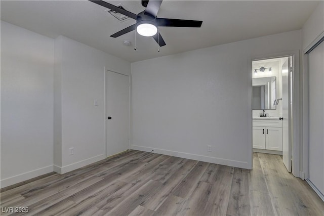 1901 Farnam Pl, Las Vegas, NV 89102 - unfurnished bedroom with light wood-type flooring, ensuite bath, baseboards, and ceiling fan