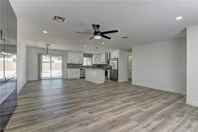 1901 Farnam Pl, Las Vegas, NV 89102 - unfurnished living room with ceiling fan, baseboards, wood finished floors, recessed lighting, and a textured ceiling