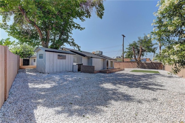 1901 Farnam Pl, Las Vegas, NV 89102 - rear view of house with board and batten siding, a fenced backyard, and an outdoor structure