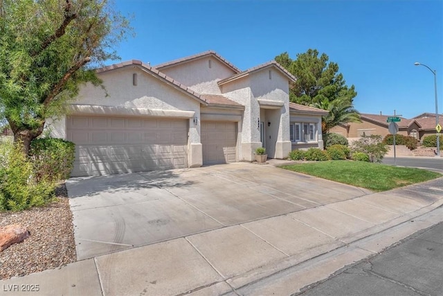 1088 Casady Hollow Ave, Henderson, NV 89012 - view of front of home with a garage, stucco siding, driveway, and a tile roof