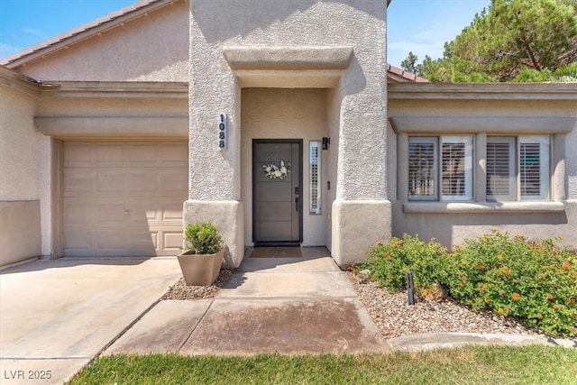 1088 Casady Hollow Ave, Henderson, NV 89012 - entrance to property featuring stucco siding, an attached garage, and concrete driveway
