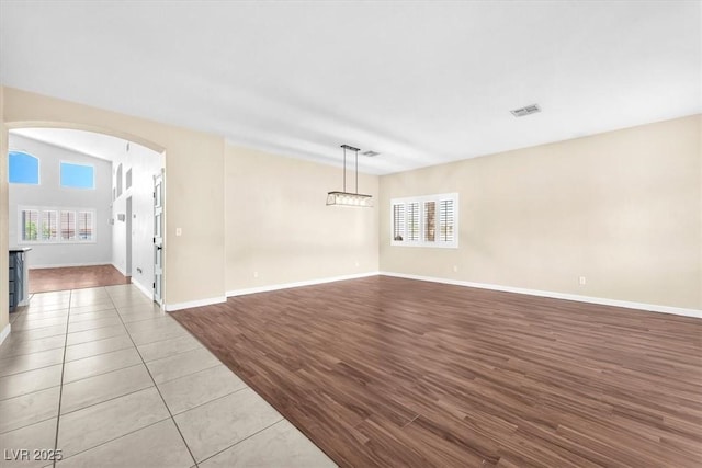 1088 Casady Hollow Ave, Henderson, NV 89012 - empty room featuring arched walkways, wood finished floors, and baseboards