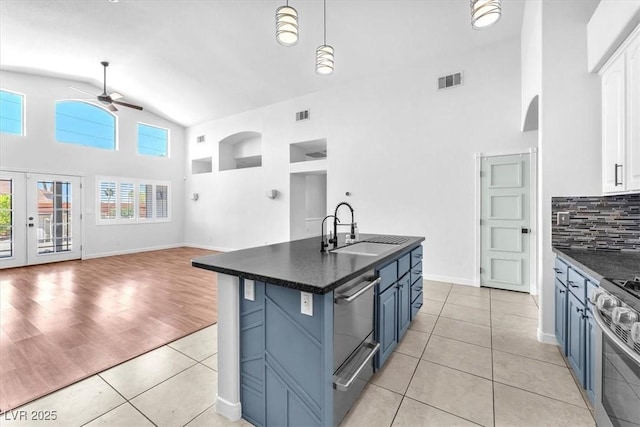1088 Casady Hollow Ave, Henderson, NV 89012 - kitchen featuring a sink, a ceiling fan, high vaulted ceiling, dark countertops, and appliances with stainless steel finishes