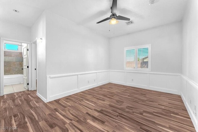1088 Casady Hollow Ave, Henderson, NV 89012 - unfurnished room featuring a ceiling fan, wood finished floors, and a wainscoted wall