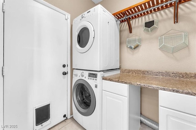1088 Casady Hollow Ave, Henderson, NV 89012 - laundry area with stacked washer and clothes dryer, heating unit, light tile patterned floors, and cabinet space