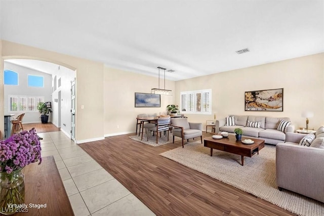 1088 Casady Hollow Ave, Henderson, NV 89012 - tiled living area featuring arched walkways and baseboards