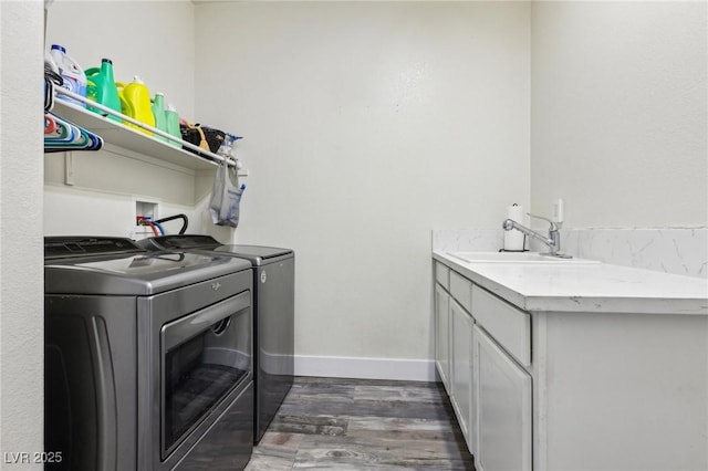 564 Lampshire Ln, Pahrump, NV 89060 - laundry room featuring washer and clothes dryer, wood finished floors, cabinet space, and baseboards