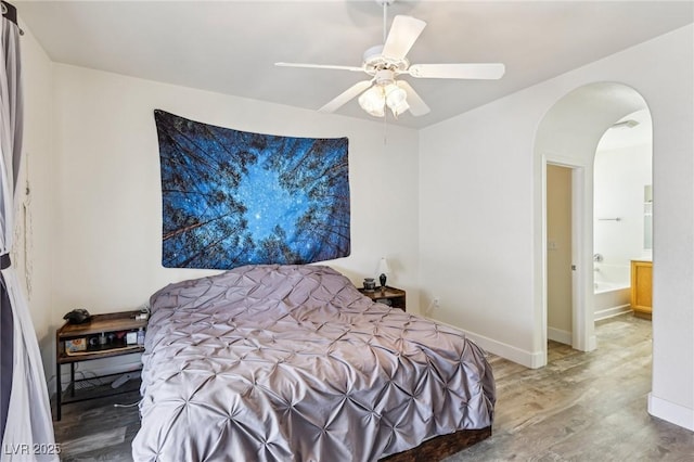 564 Lampshire Ln, Pahrump, NV 89060 - bedroom featuring wood finished floors, arched walkways, ceiling fan, and baseboards