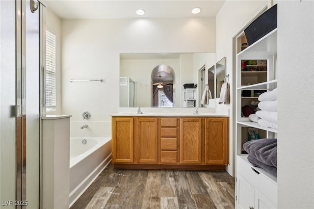 564 Lampshire Ln, Pahrump, NV 89060 - bathroom with wood finished floors, a bath, a shower stall, and double vanity