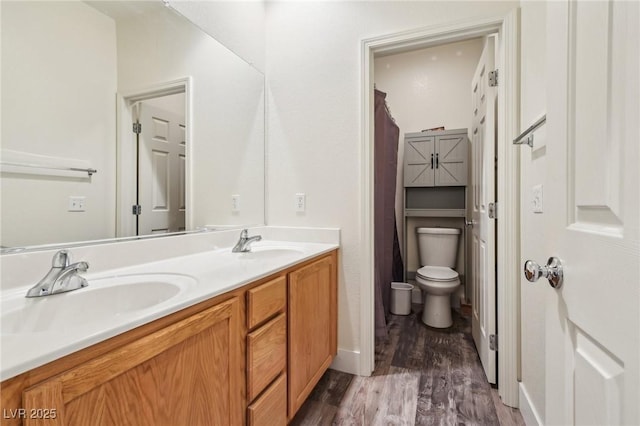 564 Lampshire Ln, Pahrump, NV 89060 - bathroom featuring wood finished floors, double vanity, and toilet