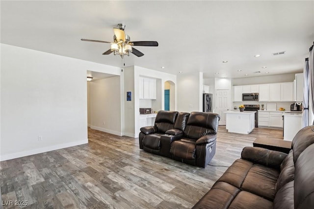 564 Lampshire Ln, Pahrump, NV 89060 - living area with a ceiling fan, arched walkways, light wood-type flooring, baseboards, and recessed lighting