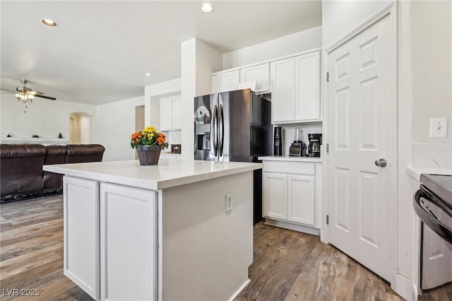 564 Lampshire Ln, Pahrump, NV 89060 - kitchen featuring black range with electric stovetop, stainless steel refrigerator with ice dispenser, a center island, wood finished floors, and recessed lighting