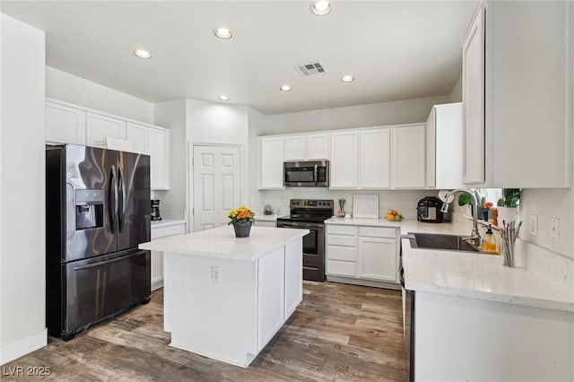 564 Lampshire Ln, Pahrump, NV 89060 - kitchen with stainless steel appliances, a sink, a center island, dark wood-style floors, and recessed lighting