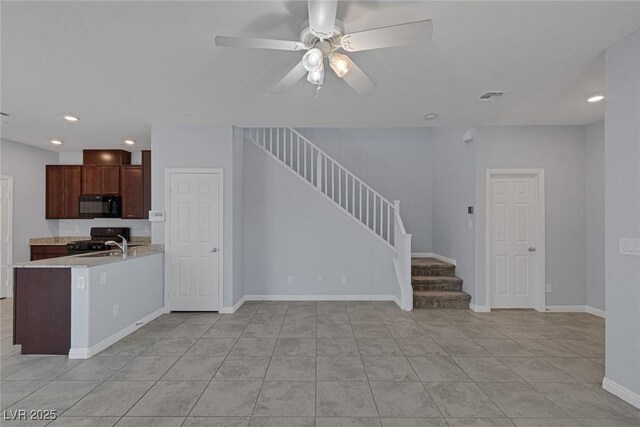 1130 Blissful Plains Ave, North Las Vegas, NV 89086 - unfurnished living room with stairs, ceiling fan, recessed lighting, light tile patterned flooring, and a sink