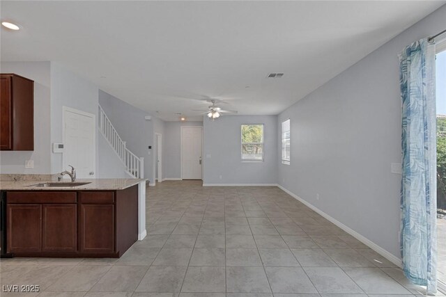 1130 Blissful Plains Ave, North Las Vegas, NV 89086 - kitchen with a sink, a ceiling fan, light tile patterned floors, recessed lighting, and light stone countertops