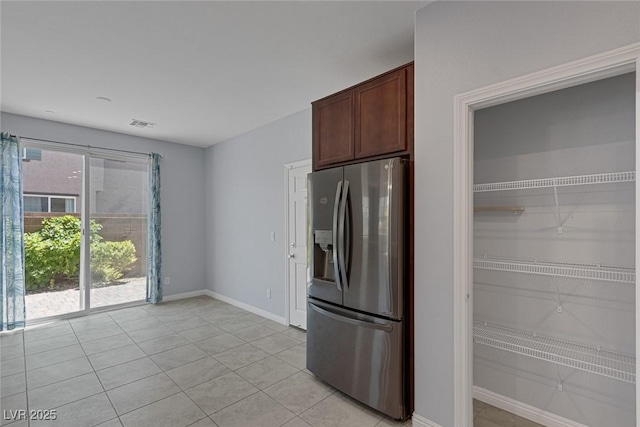 1130 Blissful Plains Ave, North Las Vegas, NV 89086 - kitchen with stainless steel fridge with ice dispenser, light tile patterned flooring, and baseboards