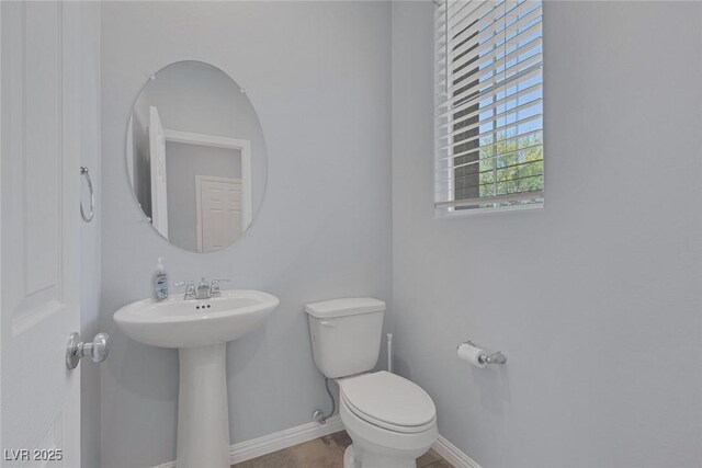 1130 Blissful Plains Ave, North Las Vegas, NV 89086 - half bath with toilet, baseboards, and a sink